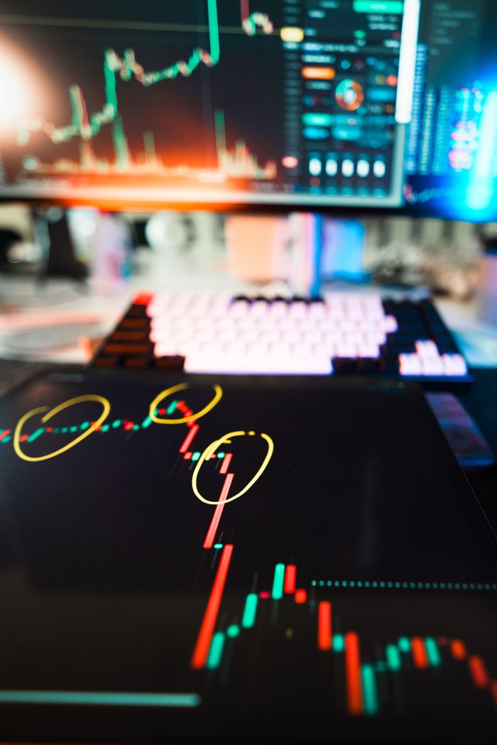 contact-img Close-up of cryptocurrency market data visualization on screens with highlighted trends and charts.